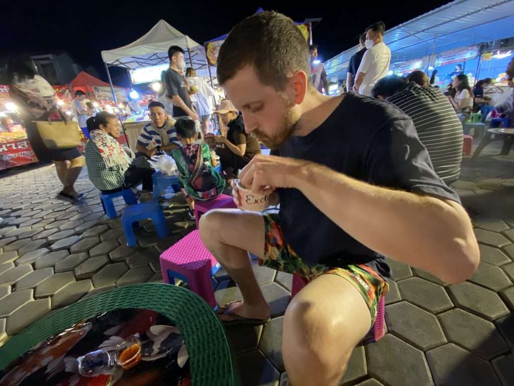 digital nomad in chiang mai Riley eating street food