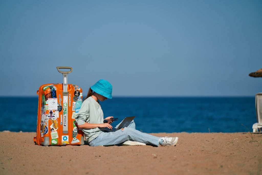 Digital nomad working on the beach