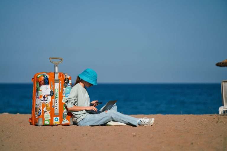 Digital nomad working on the beach
